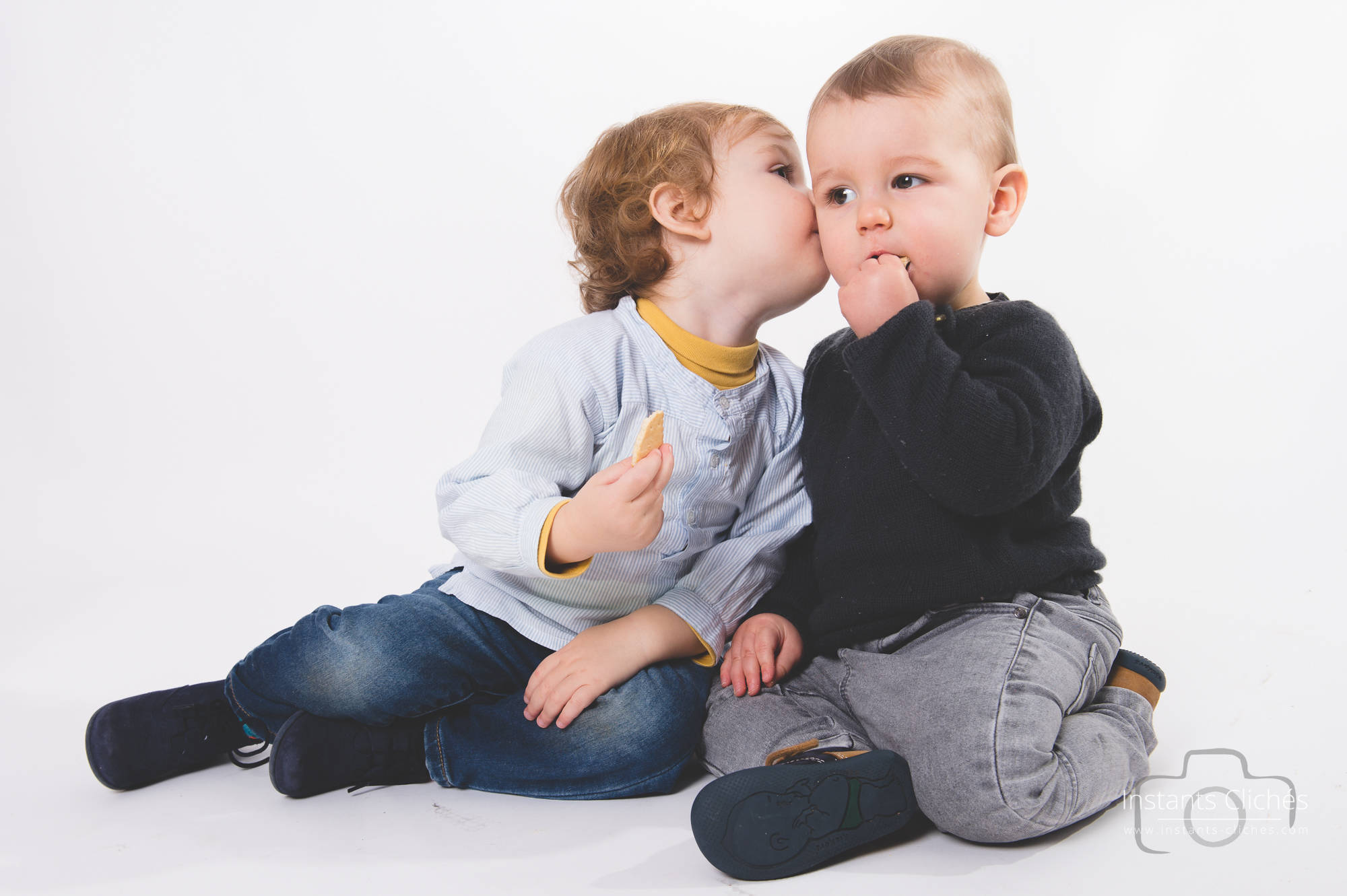 Deux jeunes enfants, un garçon et une fille, partageant un moment tendre.